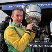 24 April 2012; Jockey Andrew Lynch celebrates with the Blessington cup after winning the Boylesports.com Champion Steeplechase on Sizing Europe. Punchestown Racing Festival, Punchestown Racecourse, Punchestown, Co. Kildare. Picture credit: Barry Cregg / SPORTSFILE