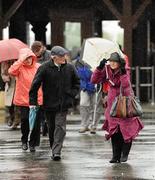 25 April 2012; Racegoers arrive during heavy rain and high winds for the second day of the Punchestown Racing Festival. Punchestown Racecourse, Punchestown, Co. Kildare. Picture credit: Stephen McCarthy / SPORTSFILE