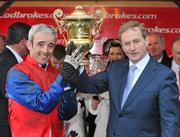 26 April 2012; An Taoiseach Enda Kenny T.D. presents the Ladbrokes.com World Series Hurdle trophy to jockey Ruby Walsh after he rode Quevega to victory. Punchestown Racing Festival, Punchestown Racecourse, Punchestown, Co. Kildare. Picture credit: Barry Cregg / SPORTSFILE