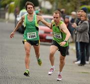22 April 2012; Jason Reid, left, Rathfarnham WSAF A.C.,  hands over to team-mate Robert Murphy for the final leg of the Senior Mens race. The Woodie’s DIY Road Relay Championships of Ireland. St. Anne's Park, Raheny, Co. Dublin. Picture credit: Tomas Greally / SPORTSFILE