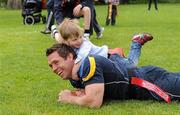 5 May 2012; Leinster rugby players Fergus McFadden, Richardt Strauss, Isaac Boss, Eoin O’Malley, Tom Sexton and Rhys Ruddock give tips to their young supporters in St. Stephen's Green, Dublin, on Saturday, 5th May. The players appeared in St. Stephen’s Green to give a surprise training session to launch the Volkswagen Leinster Rugby Summer Camps which will take place in 16 venues throughout the province in July and August. For further information please log on to www.leinsterrugby.ie. Pictured during the session are leinster's Isaac Boss with Lochlan Honan, age 3, from Drumcondra, Dublin. St. Stephen's Green, Dublin. Picture credit: Brendan Moran / SPORTSFILE