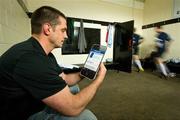 14 May 2012; Former Irish international rugby player Alan Quinlan is distracted from the game as he manages his online banking with the latest Ulster Bank banking app, the only Irish banking app available free of charge to users of iPhone, Android and Blackberry. In attendance at the launch is Alan Quinlan. Old Wesley Rugby Club, Donnybrook, Dublin. Picture credit: Brendan Moran / SPORTSFILE