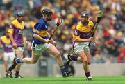 11 August 2002; Pierce White of Wexford in action against Derek Bourke of Tipperary during the All-Ireland Minor Hurling Championship Semi-Final match between Wexford and Tipperary at Croke Park in Dublin. Photo by Damien Eagers/Sportsfile