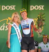 26 May 2012; Second on the stage Kai Exne, Germany Bike Aid Cycling Team, with Miss An Post Rás Cootehill Marie Langan following the seventh stage of the 2012 An Post Rás. Donegal - Cootehill. Picture credit: Stephen McCarthy / SPORTSFILE