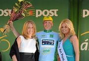 26 May 2012; Lasse Norman Hansen, Denmark Blue Water Cycling, is presented with his One Direct stage winners jersey by Alison Hennessy, One Direct, Business Development Manager, and Miss An Post Rás Cootehill Marie Langan following the seventh stage of the 2012 An Post Rás. Donegal - Cootehill. Picture credit: Stephen McCarthy / SPORTSFILE