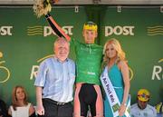 26 May 2012; Marcin Biablocki, Node4 Giordana, is presented with the An Post points leader jersey by John Foy, An Post Postmaster, Cootehill, and Miss An Post Rás Cootehill Marie Langan following the seventh stage of the 2012 An Post Rás. Donegal - Cootehill. Picture credit: Stephen McCarthy / SPORTSFILE