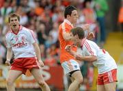 10 June 2012; Mark Bradley, Tyrone, celebrates with team-mate Sean Hackett, left, after scoring his side's second goal, as Armagh's Donal O'Neill reacts. Ulster GAA Football Senior Championship, Quarter-Final, Armagh v Tyrone, Morgan Athletic Grounds, Armagh. Picture credit: Brian Lawless / SPORTSFILE