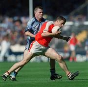 1 September 2002; Paul McGrane of Armagh is tackled by Dessie Farrell of Dublin during the Bank of Ireland All-Ireland Senior Football Championship Semi-Final match between Armagh and Dublin at Croke Park in Dublin. Photo by Damien Eagers/Sportsfile