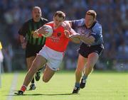 1 September 2002; Paddy McKeever of Armagh is tackled by Peadar Andrews of Dublin during the Bank of Ireland All-Ireland Senior Football Championship Semi-Final match between Armagh and Dublin at Croke Park in Dublin. Photo by Ray McManus/Sportsfile
