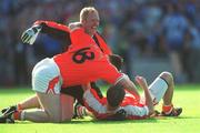 1 September 2002; Armagh players Cathal O'Rourke, 18, Brendan Tierney, centre, and Enda McNulty celebrate at the final whistle of the Bank of Ireland All-Ireland Senior Football Championship Semi-Final match between Armagh and Dublin at Croke Park in Dublin. Photo by Pat Murphy/Sportsfile