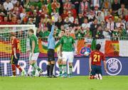 14 June 2012; Glenn Whelan, Republic of Ireland, is shown a yellow card by referee Pedro Proença following a foul on Spain's David Silva. EURO2012, Group C, Spain v Republic of Ireland, Arena Gdansk, Gdansk, Poland. Picture credit: Stephen McCarthy / SPORTSFILE