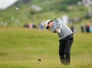 28 June 2012; Alan Dunbar plays his second shot to the 16th green during the 2012 Irish Open Golf Championship. Royal Portrush, Portrush, Co. Antrim. Picture credit: Oliver McVeigh / SPORTSFILE