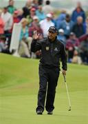 28 June 2012; Jeev Milkha Singh acknowlwdges the crowd after his birdie putt on the 18th Green to take the outright lead, during the 2012 Irish Open Golf Championship. Royal Portrush, Portrush, Co. Antrim. Picture credit: Oliver McVeigh / SPORTSFILE