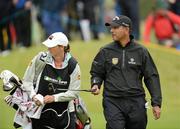 28 June 2012; Jeev Milkha Singh, along with his caddie Janet Squire, coming off the 18th green to take an early outright lead, during the 2012 Irish Open Golf Championship. Royal Portrush, Portrush, Co. Antrim. Picture credit: Oliver McVeigh / SPORTSFILE