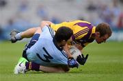 1 July 2012; Rory O'Carroll, Dublin, tackles Wexford forward Paddy Byrne. He was issued with a yellow card for the tackle. Leinster GAA Football Senior Championship Semi-Final, Dublin v Wexford, Croke Park, Dublin. Picture credit: Ray McManus / SPORTSFILE