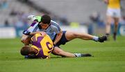 1 July 2012; Rory O'Carroll, Dublin, tackles Wexford forward Paddy Byrne. He was issued with a yellow card for the tackle. Leinster GAA Football Senior Championship Semi-Final, Dublin v Wexford, Croke Park, Dublin. Picture credit: Ray McManus / SPORTSFILE