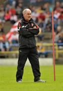 14 July 2012; Tyrone manager Mickey Harte watches his team warming up before the game. GAA Football All-Ireland Senior Championship Qualifier, Round 2, Roscommon v Tyrone, Dr. Hyde Park, Roscommon. Picture credit: Barry Cregg / SPORTSFILE