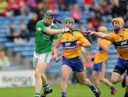 14 July 2012; Wayne McNamara, Limerick, scores the first goal of the game despite the tackles from Cian Dillon, right, and Sean Collins, 9, Clare. GAA Hurling All-Ireland Senior Championship, Phase 3, Limerick v Clare, Semple Stadium, Thurles, Co. Tipperary. Picture credit: Matt Browne / SPORTSFILE