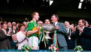 28 September 1997; Kerry captain Liam Hassett is presented with the Sam Maguire Cup by GAA President Joe McDonagh after GAA Football All-Ireland Senior Championship Final match between Kerry and Mayo at Croke Park in Dublin. Photo by Brendan Moran/Sportsfile