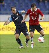 9 August 2012; Sean O'Connor, St Patrick's Athletic, in action against Szabolc Huszti, Hannover 96. UEFA Europa League, 3rd Qualifying Round, Second Leg, Hannover 96 v St Patrick's Athletic, AWD-Arena, Robert-Enke-Street, Hannover, Germany. Picture credit: Joachim Sielski / SPORTSFILE