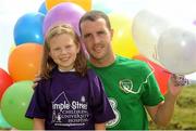 14 August 2012; Temple Street were joined by John O’Shea, who will captain the Republic of Ireland Ireland in their away international friendly against Serbia on Wednesday, and Shane Long to announce the details of Support Your Colours Ball, supported by Mercury in aid of Temple Street Children’s University Hospital. For more information contact Temple Street on 01-878 4344 or visit www.templestreet.ie. Pictured here are 9 year old Caoimhe Neill, from Malahide, Co. Dublin, with Republic of Ireland's John O'Shea. Portmarnock Hotel & Golf Links, Portmarnock, Dublin. Photo by Sportsfile