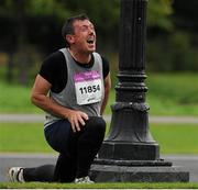 25 August 2012; David Hogan, from Co. Dublin, stretches out after completing the Frank Duffy 10 Mile. Phoenix Park, Dublin. Picture credit: Tomas Greally / SPORTSFILE