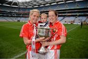 7 October 2012; One year old Megan Walsh, from Killeagh, Cork, with her godmother Anne Marie Walsh, right, and Angela Walsh celebrate with the Brendan Martin Cup.  TG4 All-Ireland Ladies Football Senior Championship Final, Cork v Kerry, Croke Park, Dublin. Picture credit: Ray McManus / SPORTSFILE