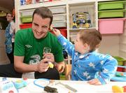 9 October 2012; Republic of Ireland's John O'Shea has his ear checked by Ryan Keane, age 2, from Cabra, Dublin, on a visit to Temple Street Children's Hospital ahead of their FIFA World Cup Qualifier match against Germany on Friday. Temple Street Children's Hospital, Temple Street, Dublin. Picture credit: David Maher / SPORTSFILE