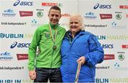 29 October 2012; Third placed in the national men's marathon championships Barry Minnock, Co. Offaly, with Georgina Drumm, Vice President, Athletics Association of Ireland, after during the Dublin Marathon 2012. Merrion Square, Dublin. Picture credit: Brendan Moran / SPORTSFILE