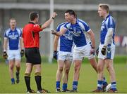 11 November 2012; Matthew Byrne, St. Patrick's, reacts to referee David Gough, alongside team-mates Patrick McWalter, left, and Tommy Kelly, right, after a foul was given against him. AIB Leinster GAA Football Senior Championship Quarter-Final, St. Patrick's, Wicklow v Portlaoise, Co. Laois, County Grounds, Aughrim, Co. Wicklow. Picture credit: Barry Cregg / SPORTSFILE