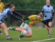 10 February 2013; Geraldine McLaughlin, Donegal, scores her side's second goal despite the challenge of Dublin's Natalia Hyland. TESCO HomeGrown Ladies National Football League, Division 1, Round 2, Chanel College, Coolock, Dublin. Picture credit: Pat Murphy / SPORTSFILE