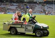 28 April 2013; Derry corner forward Raymond Wilkinson is comforted by a member of The St. John Ambulance Brigade of Ireland as he leaves the field on a stretcher. Allianz Football League Division 2 Final, Derry v Westmeath, Croke Park, Dublin. Picture credit: Ray McManus / SPORTSFILE