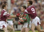 6 July 2003; Mayo's Declan Sweeney is tackled by Galway's Joe Bergin, right, and Jarlath Fallon. Bank of Ireland Connacht Senior Football Championship Final, Galway v Mayo, Pearse Stadium, Galway. Picture credit; Damien Eagers / SPORTSFILE *EDI*