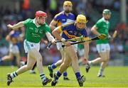 9 June 2013; David Young, Tipperary, in action against Willie Griffin, Limerick. Munster GAA Hurling Intermediate Championship Semi-Final, Limerick v Tipperary, Gaelic Grounds, Limerick. Picture credit: Pat Murphy / SPORTSFILE